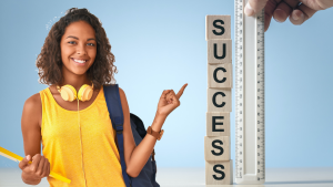 Female student pointing at ruler with the word "Success" next to it.