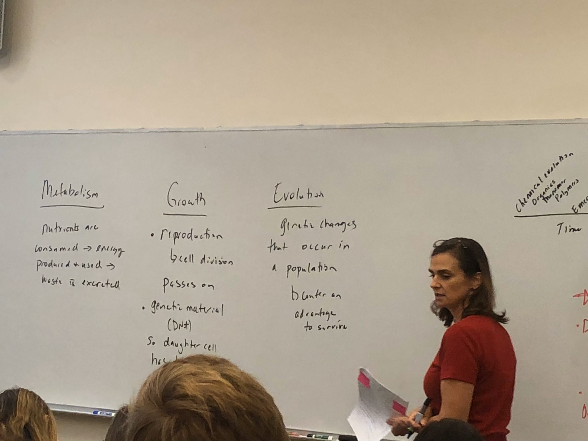 A Denison professor teaching with mutation, growth, and evolution written on the whiteboard